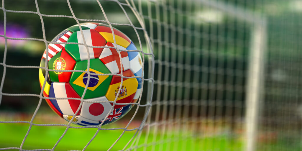 Football ball with flags of world countries in the net of goal o